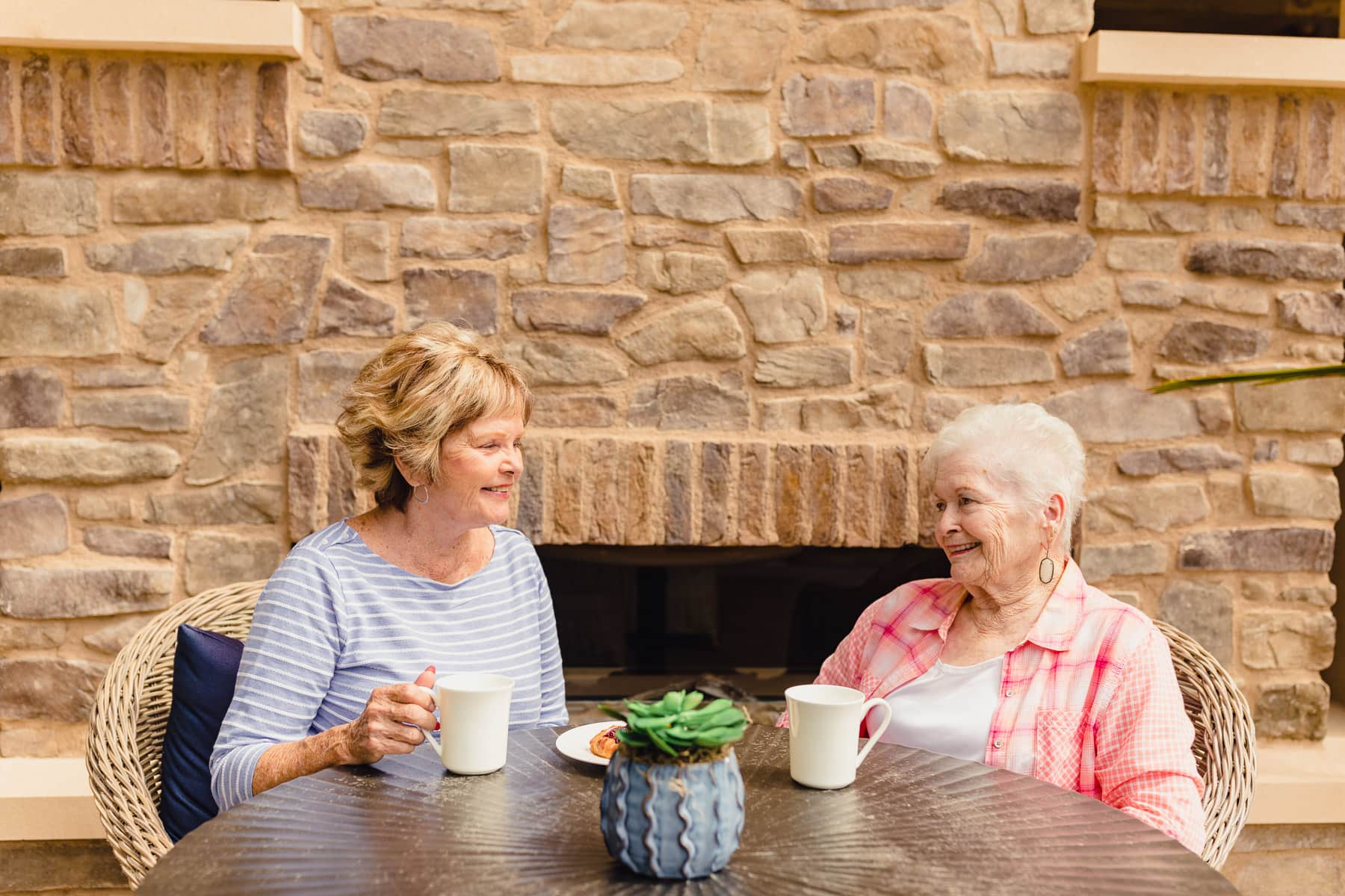 elderly resident and family member having coffee