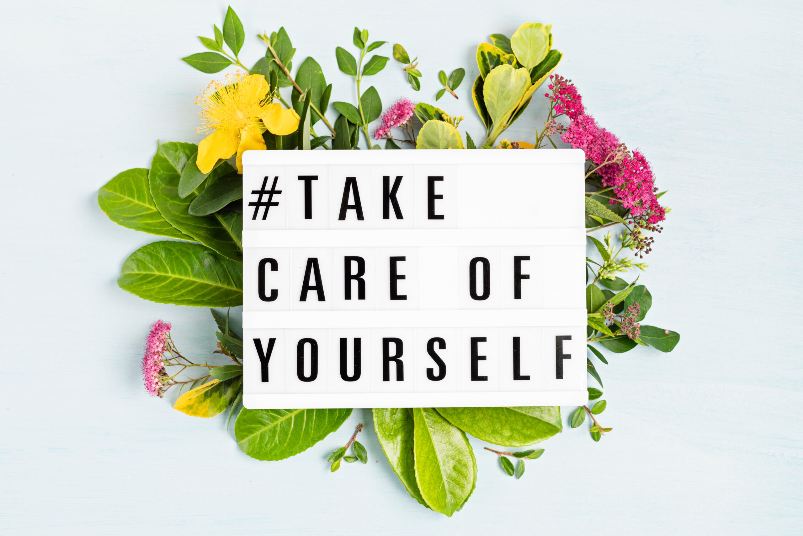 sign that says take care of yourself with flowers