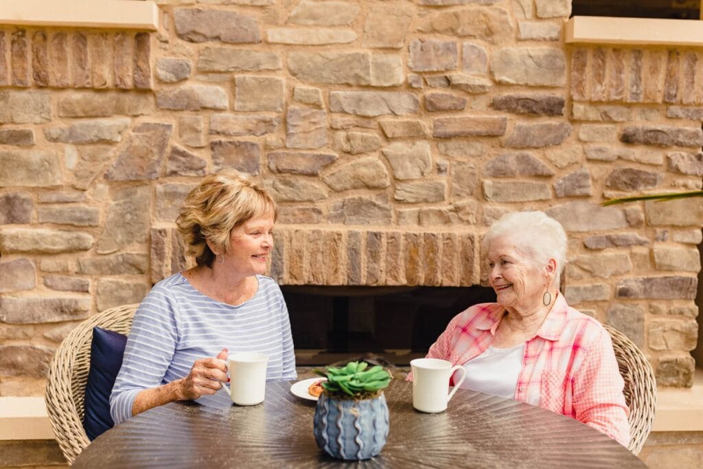 elderly resident and family member having coffee