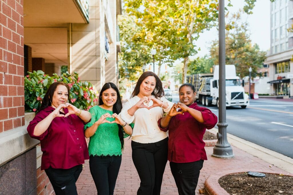 team members making hearts with their hands