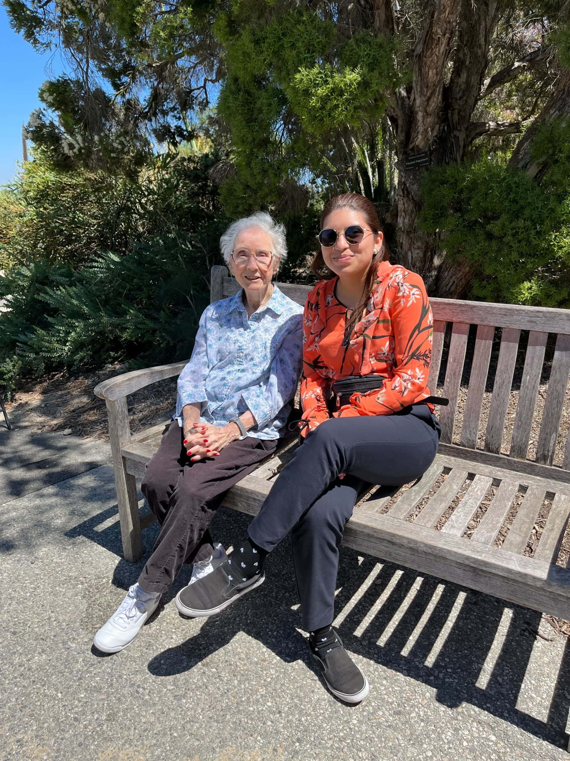 care team member and resident sitting on bench together