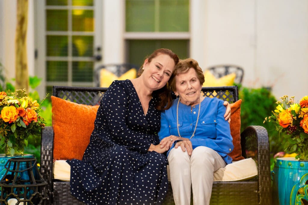 two ladies sitting on a bench together
