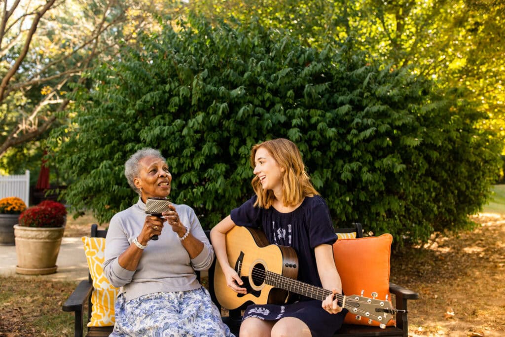 two women singing and playing guitar