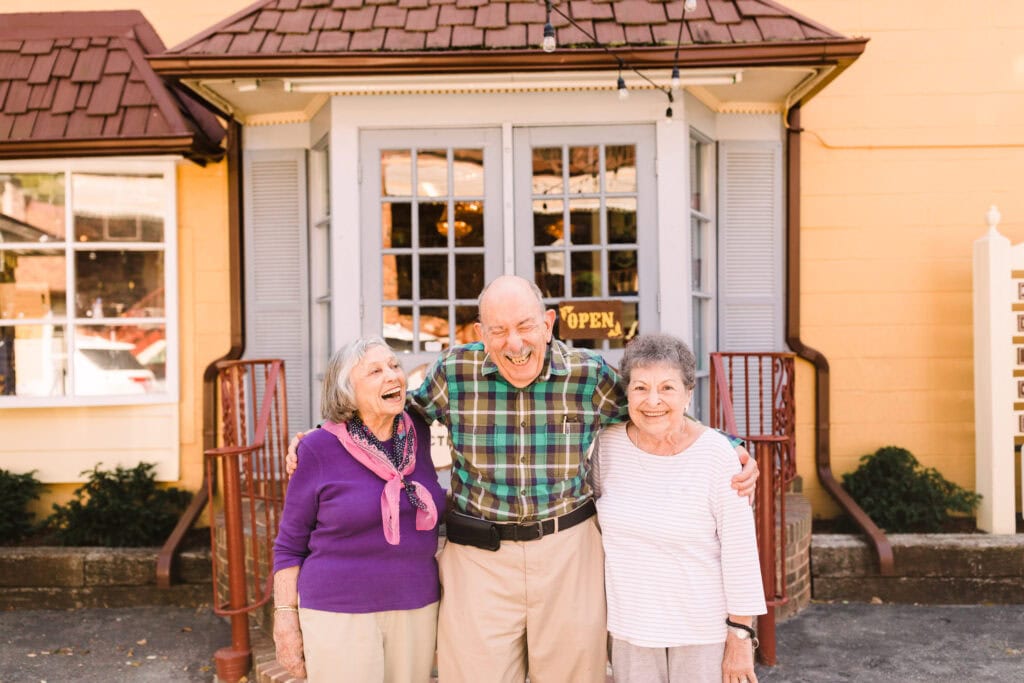 older man and two older women laughing together