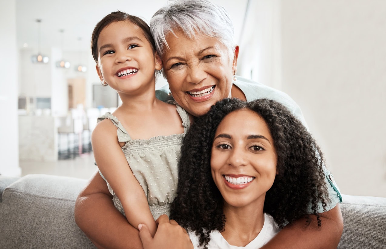 Family, generations and hug with love in portrait and care at home, mother and grandmother with child together and smile. Happiness, relationship and wellness, women and girl quality time together