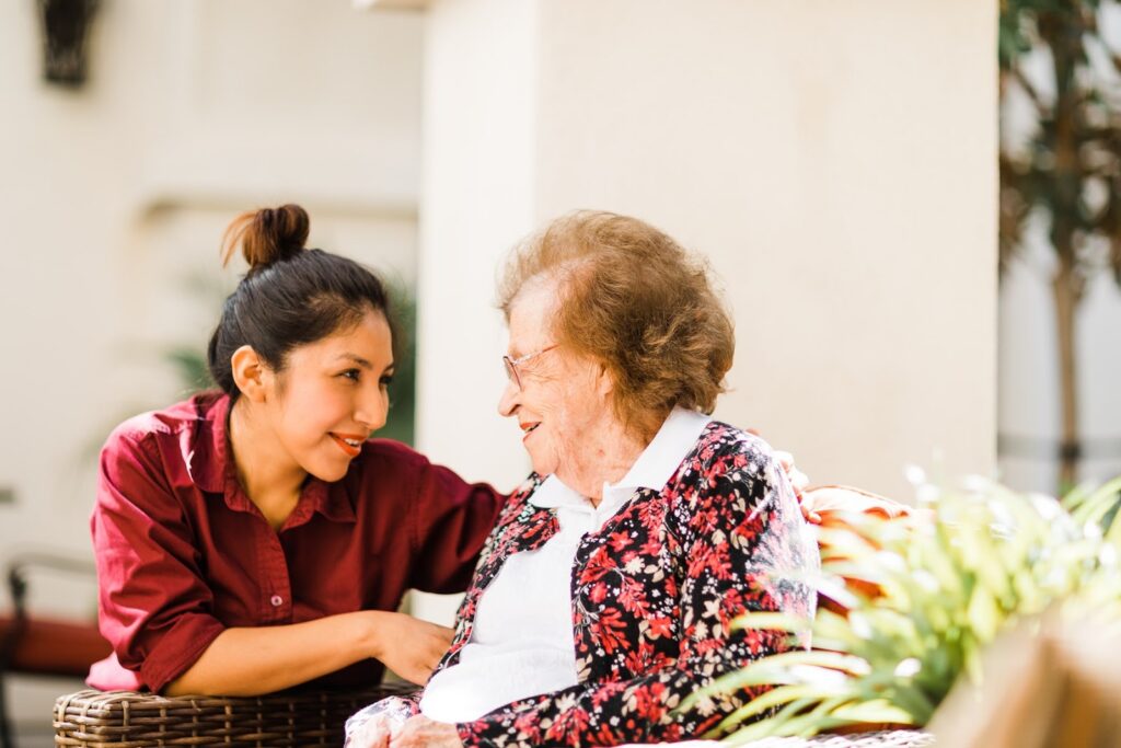 kensington team member helping a senior woman