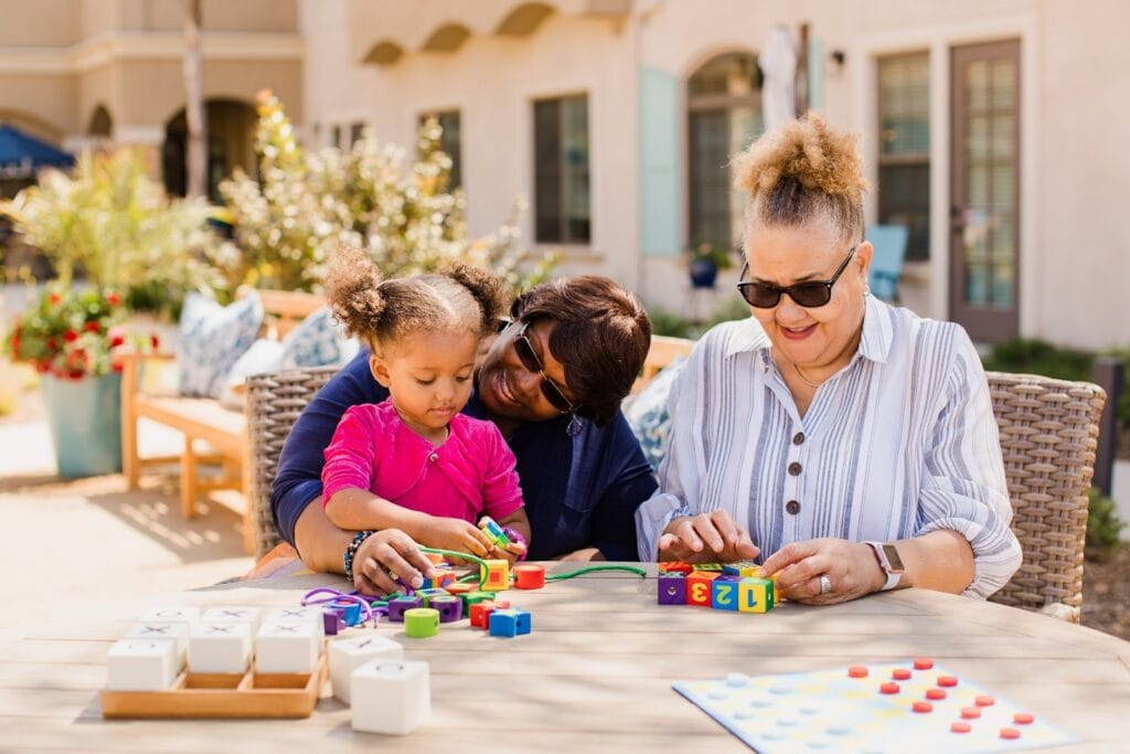 a senior spending time with their family at kensington senior living community
